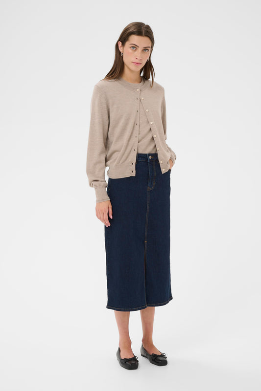 Woman wearing a camel coloured cardigan with a denim skirt