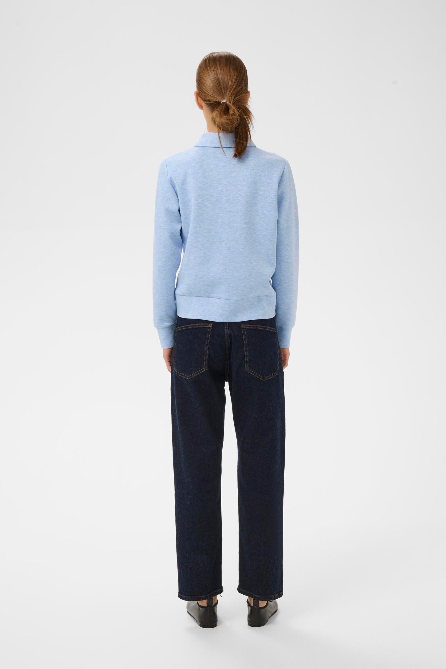 Woman wearing the InWear Beca cardigan with collar, front pockets and zip fastening. In Endless sky blue colour.