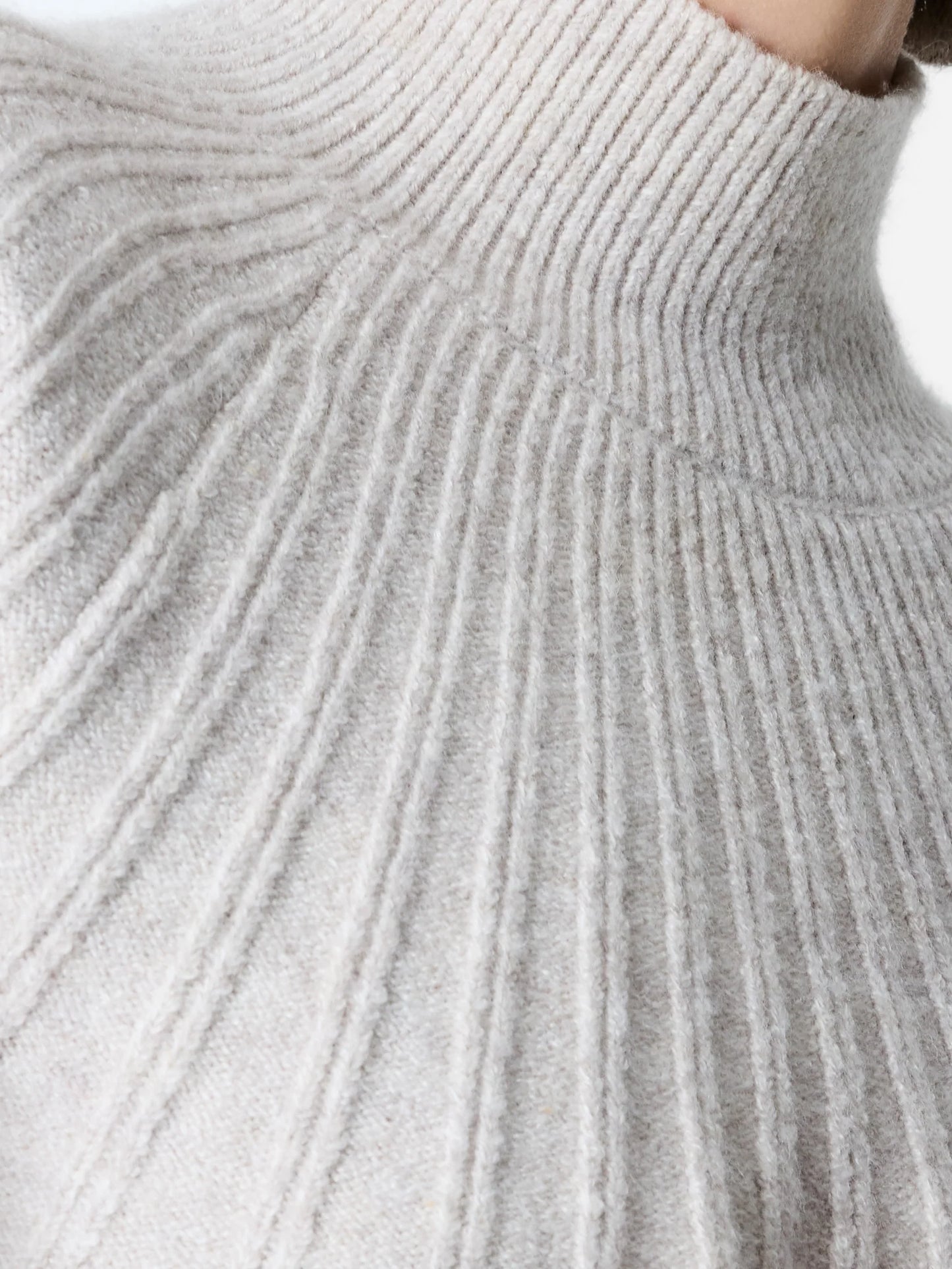 woman wearing a ribbed light colour jumper with a mock neck. Close up of neck detail