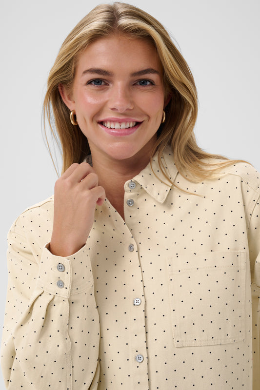 Woman wearing the Saint Tropez Patricia beige polka dot shirt
