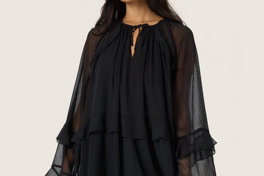 Woman wearing the Soaked in Luxury Harietta knee length floaty chiffon dress with long sleeves