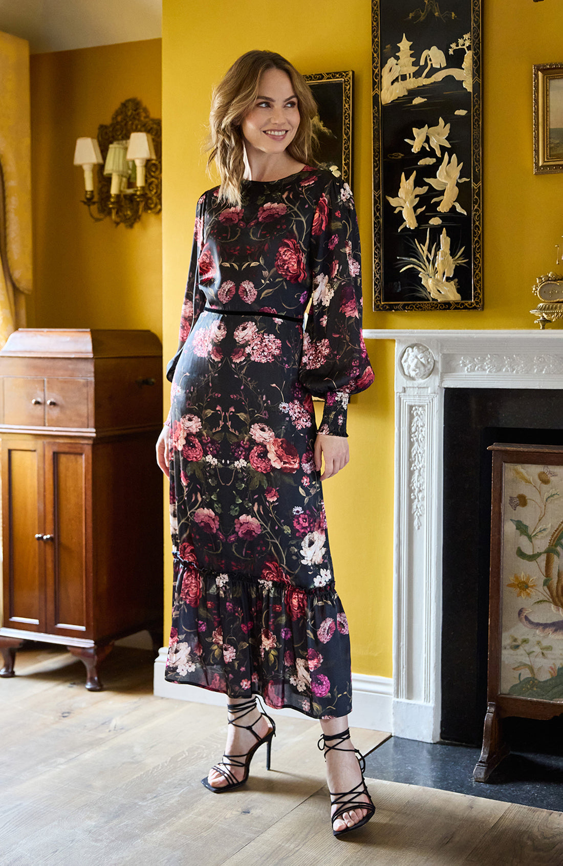 Woman wearing the Holly floral dress with long sleeves on a white background, featuring the brand 'Hope & Ivy'.