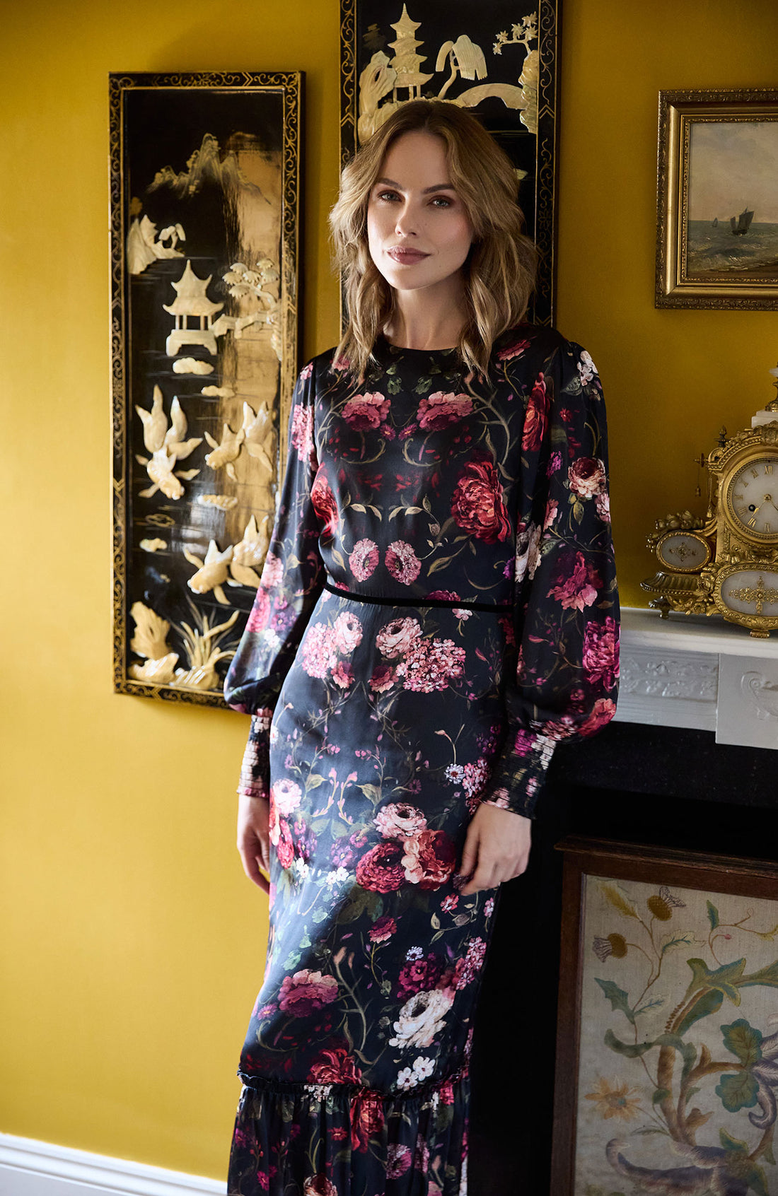 Woman wearing the Holly floral dress with long sleeves on a white background, featuring the brand 'Hope & Ivy'.