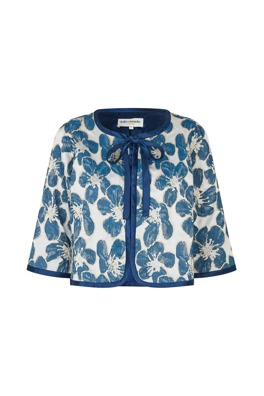 Trine feminine jacket featuring a woven floral design in blue, elegant tie-front fastening and wide sleeves.