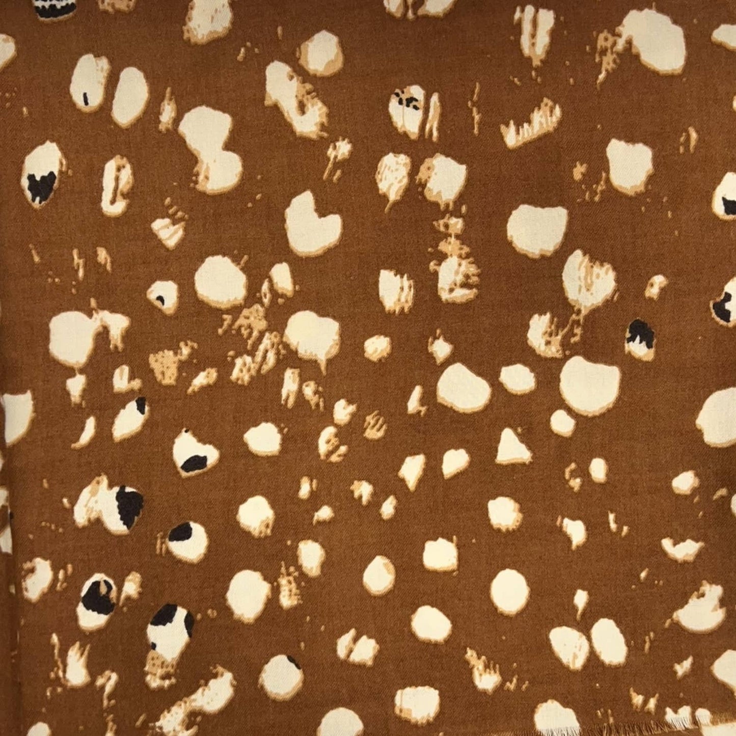 Brown scarf with beige abstract pattern on a white background