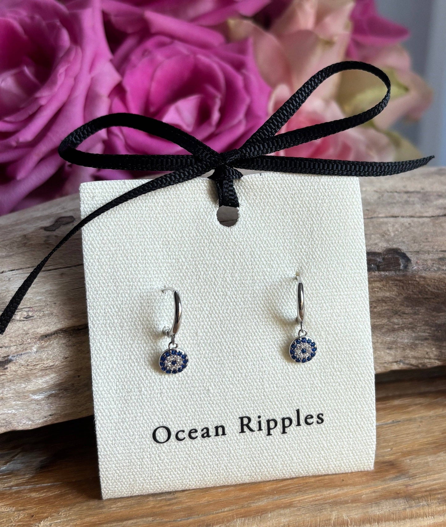 Ocean Ripples 925 sterling silver blue cubic zirconia huggie earrings.
