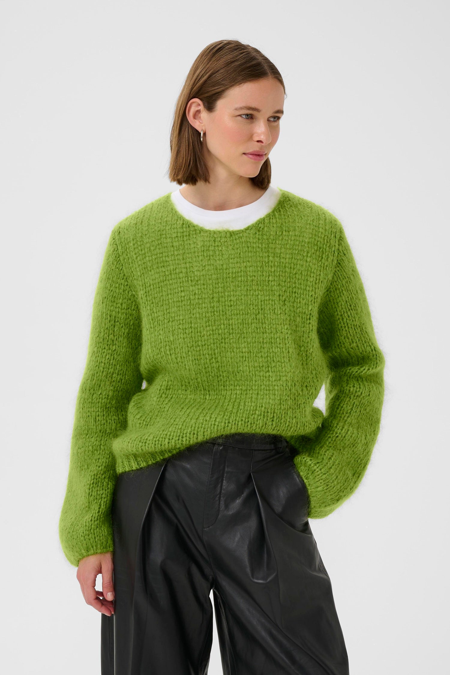 Lady wearing a bright green mohair jumper