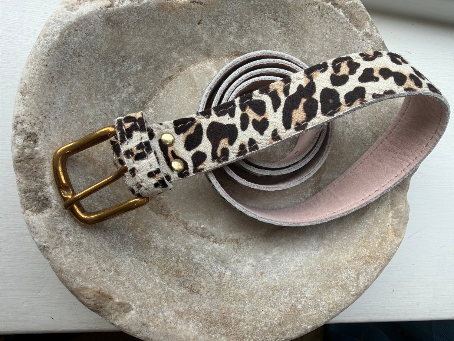 Leopard Print Leather belt on a stone background
