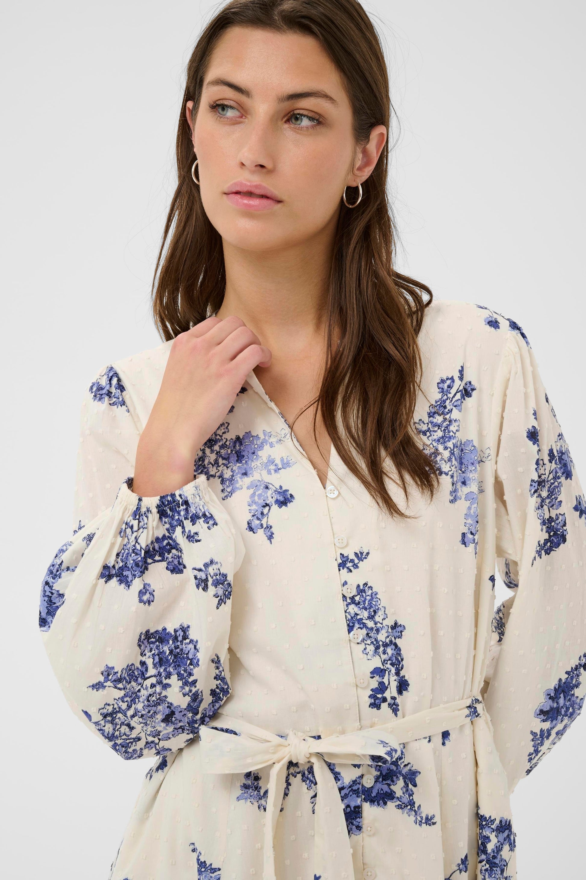 Woman wearing the Part Two Avira White and Blue floral dress on a white background