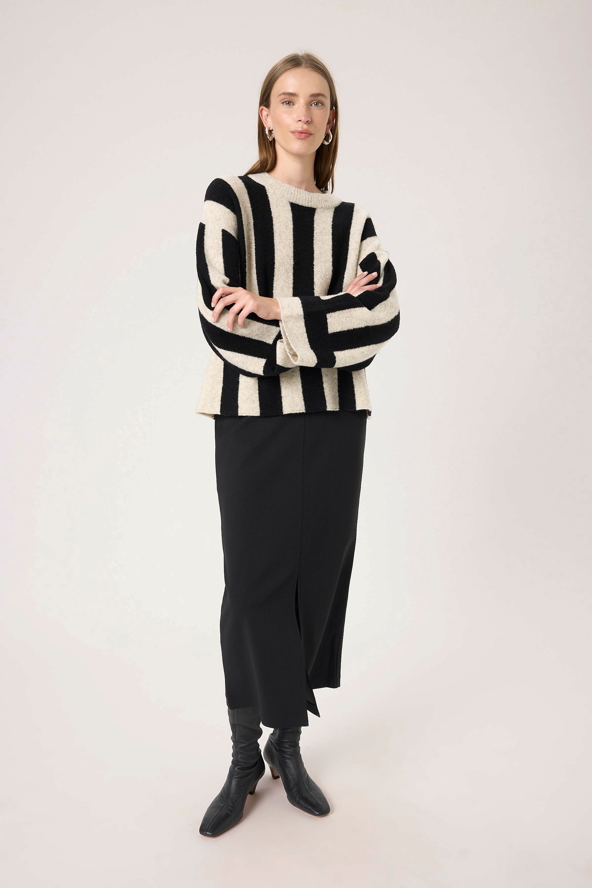 Woman wearing  The soaked in luxury briony black and white striped sweater .