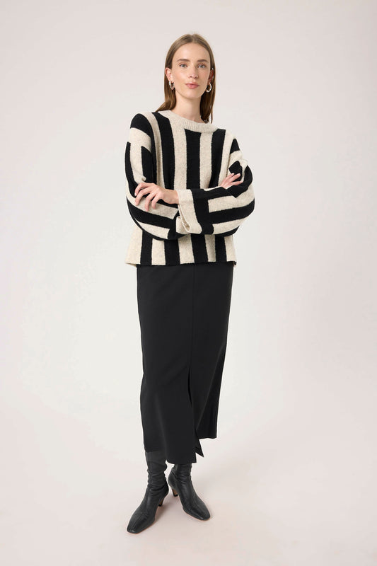 Woman wearing  The soaked in luxury briony black and white striped sweater .