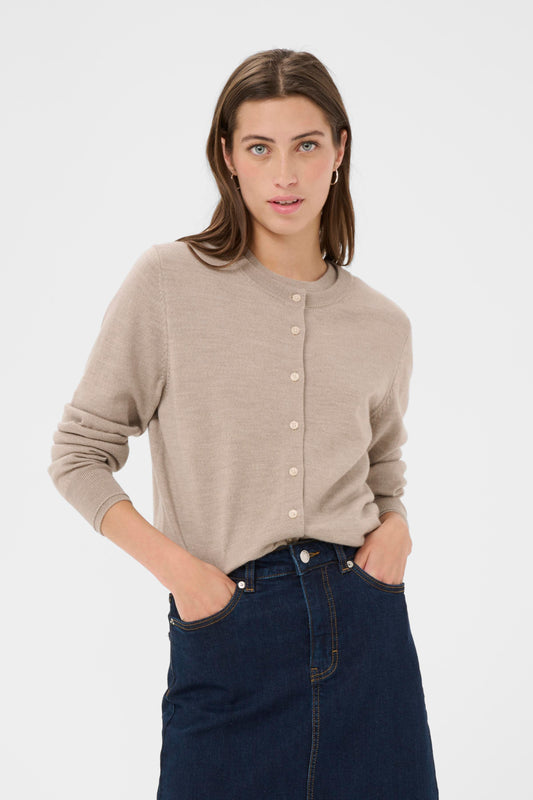 Woman wearing a camel coloured cardigan with a denim skirt