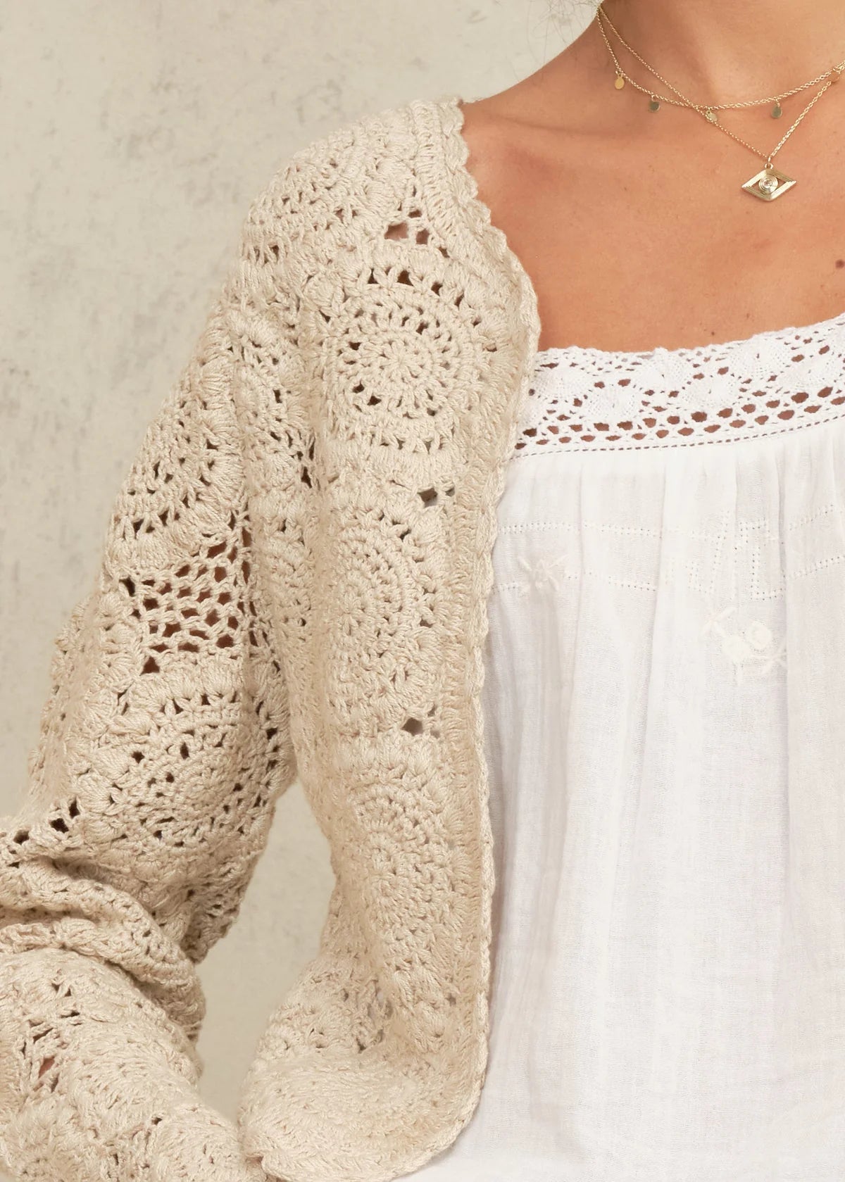Woman wearing the M.A.B.E Maci  beige crochet cardigan 