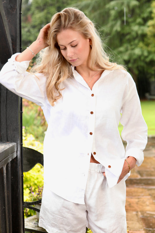 Woman wearing the Dear Prudence White Freddie Shirt in 100% European flax linen with bamboo buttons and a relaxed longer back.