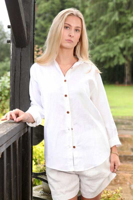 Woman wearing the Dear Prudence White Freddie Shirt in 100% European flax linen with bamboo buttons and a relaxed longer back.