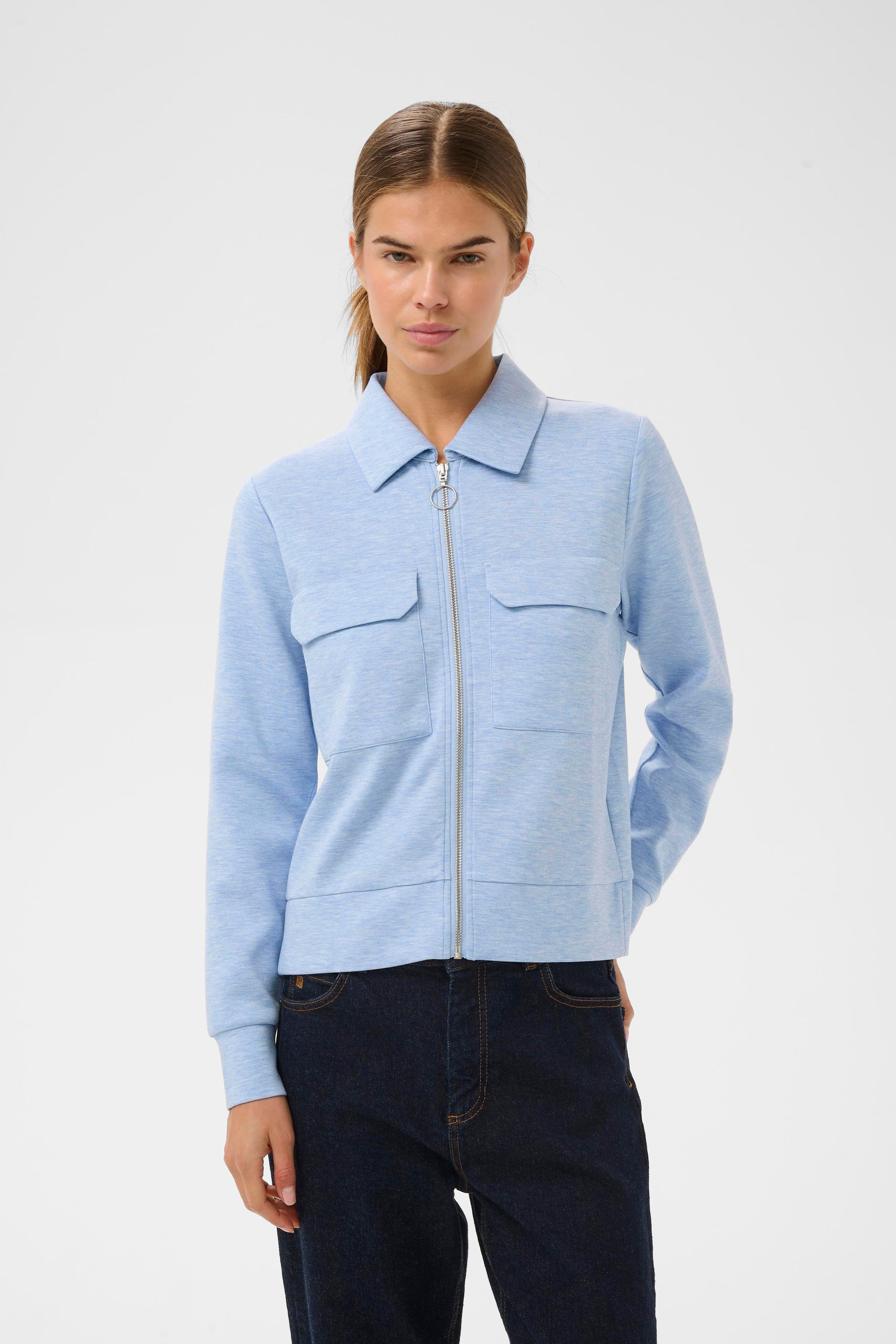 Woman wearing the InWear Beca cardigan with collar, front pockets and zip fastening.  In Endless sky blue colour.