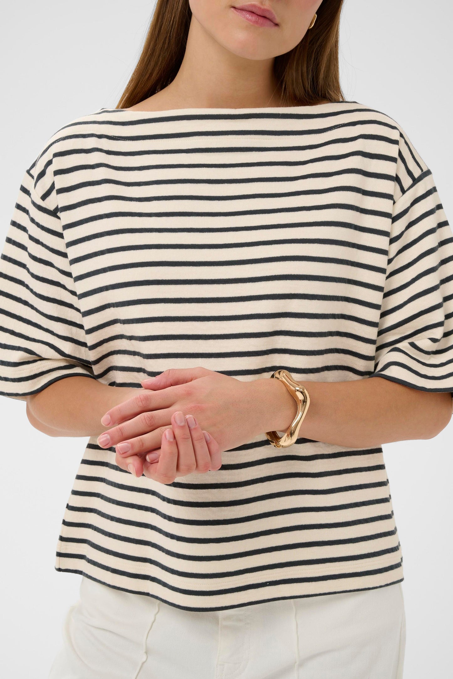 Woman wearing a soaked in luxury black and white striped short sleeved jumper