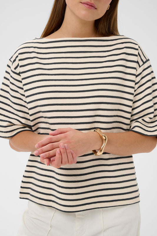 Woman wearing a soaked in luxury black and white striped short sleeved jumper