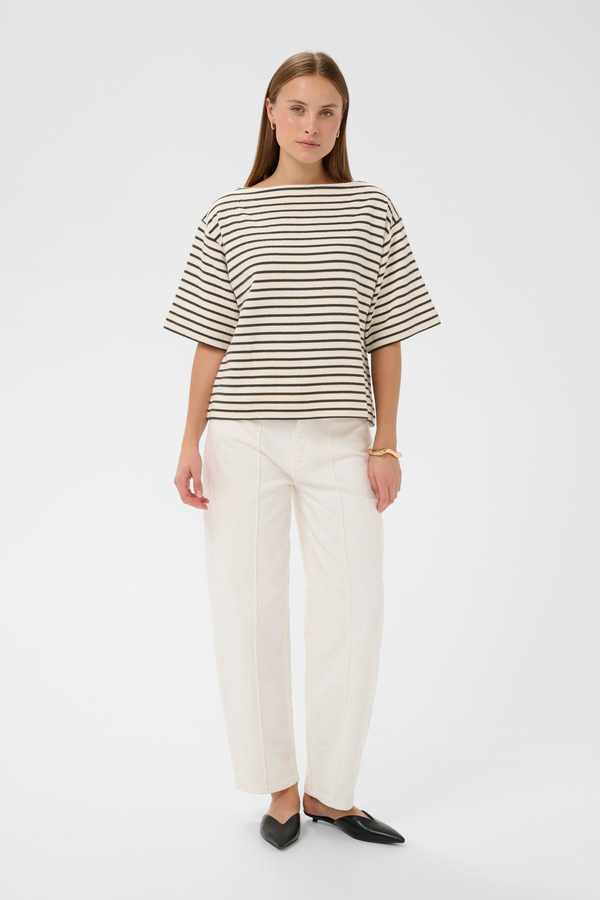 Woman wearing a soaked in luxury black and white striped short sleeved jumper