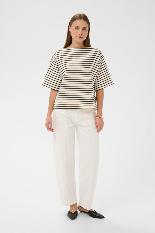 Woman wearing a soaked in luxury black and white striped short sleeved jumper