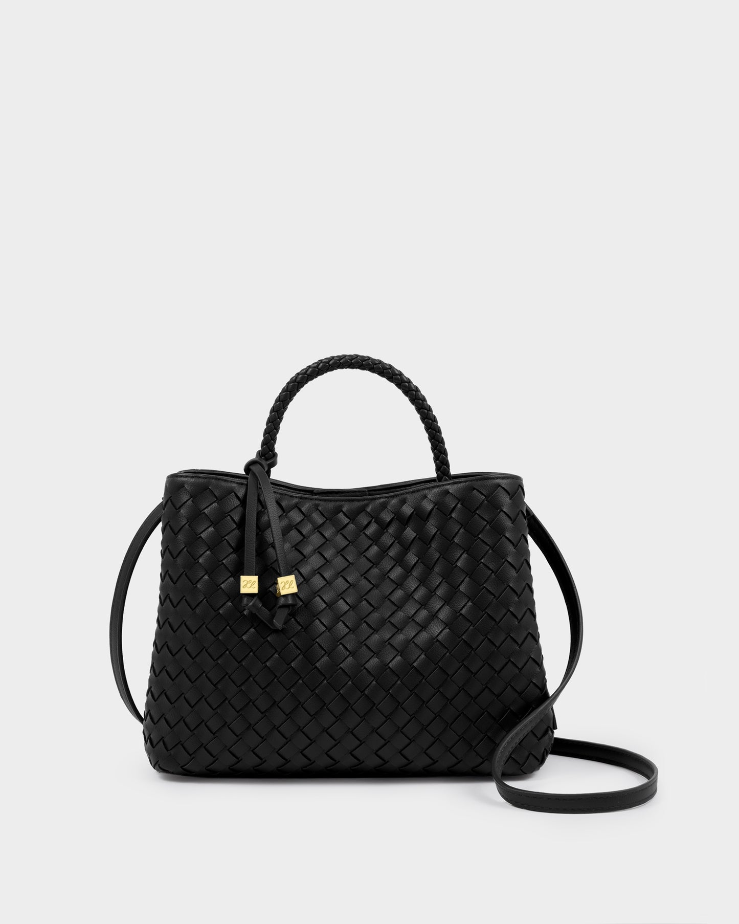 Katie Loxton Nova Black woven handbag with a strap on a light gray background