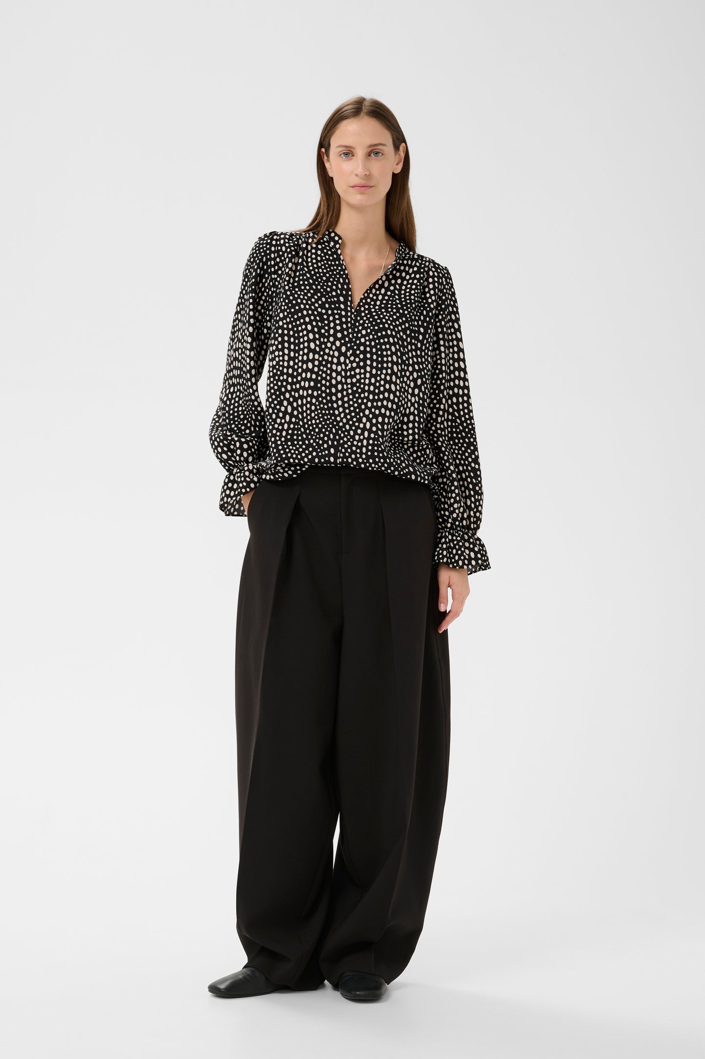 Woman wearing the Inwear Liberty black blouse with white dots on it