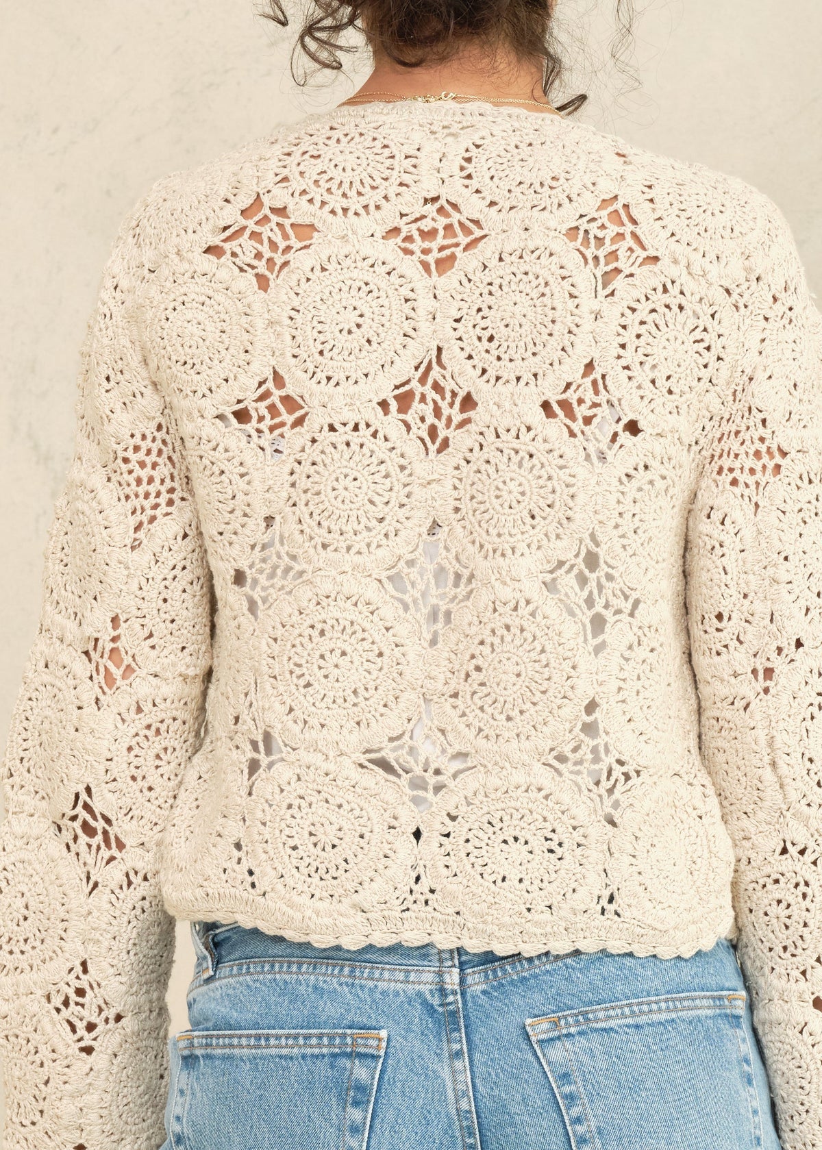 Woman wearing the M.A.B.E Maci  beige crochet cardigan 
