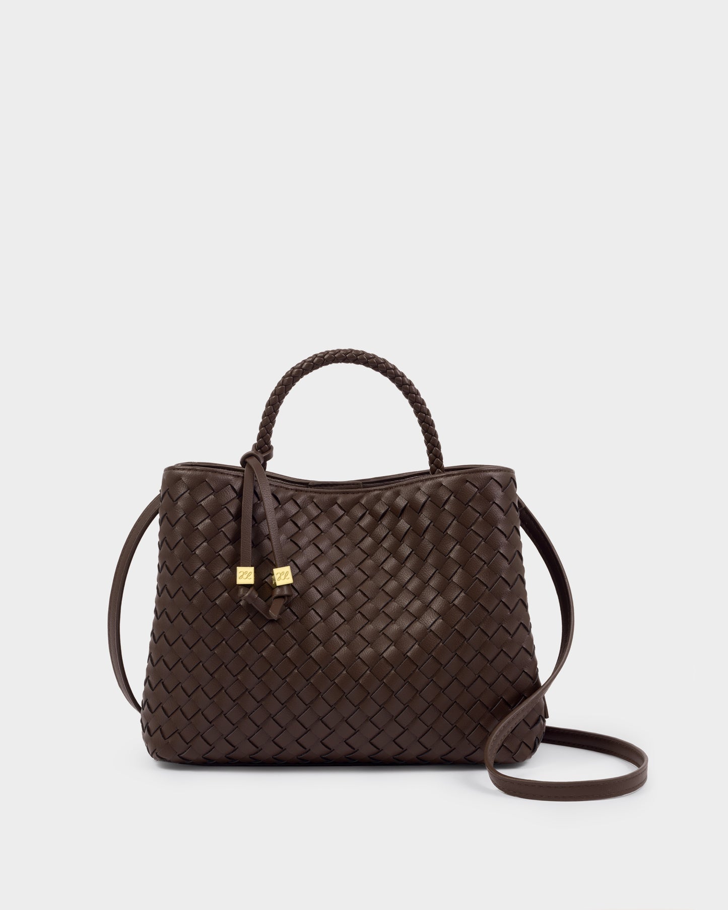 Katie Loxton Nova Brown woven handbag with a strap on a light gray background