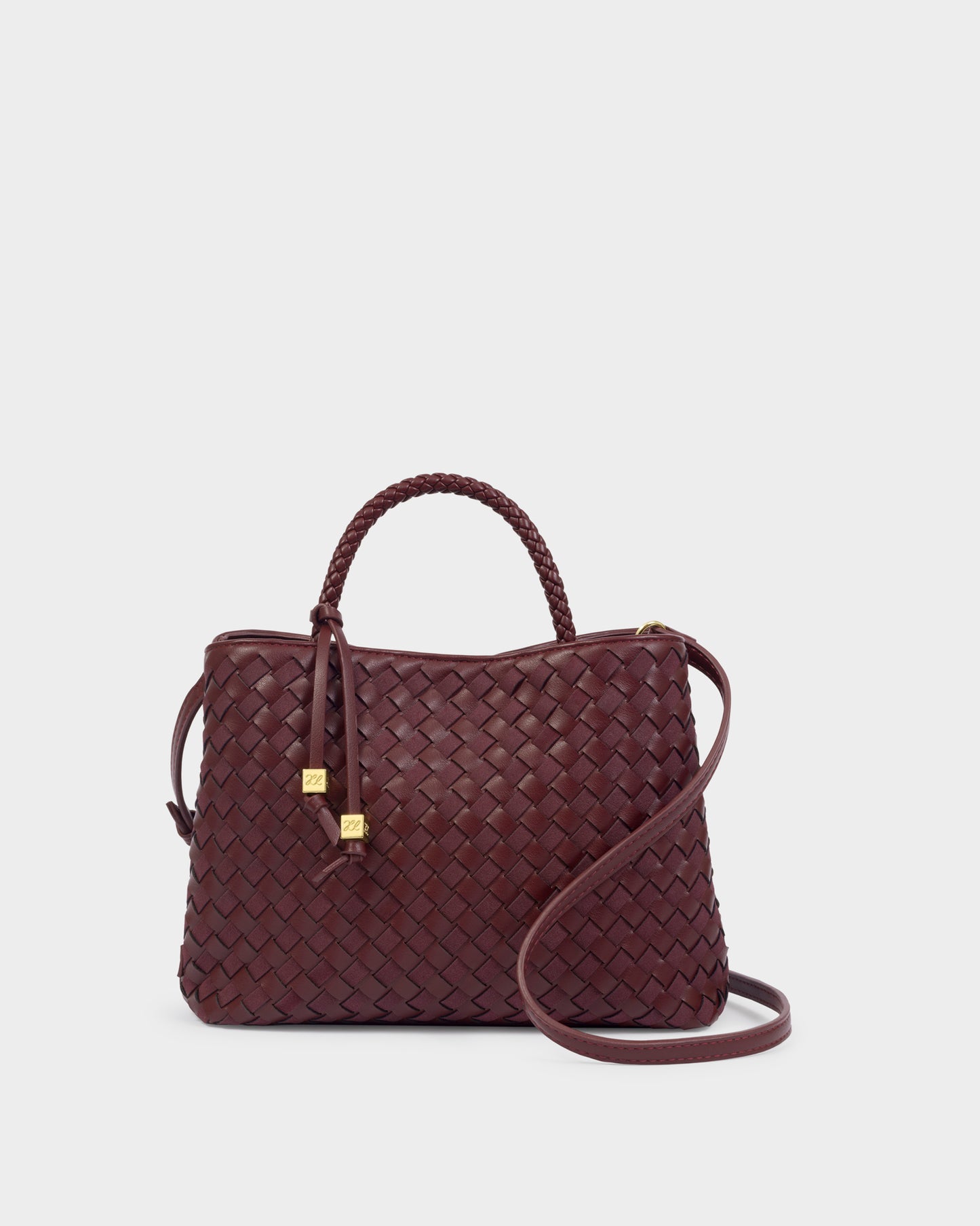 Katie Loxton Nova Cherry woven handbag with a strap on a light gray background