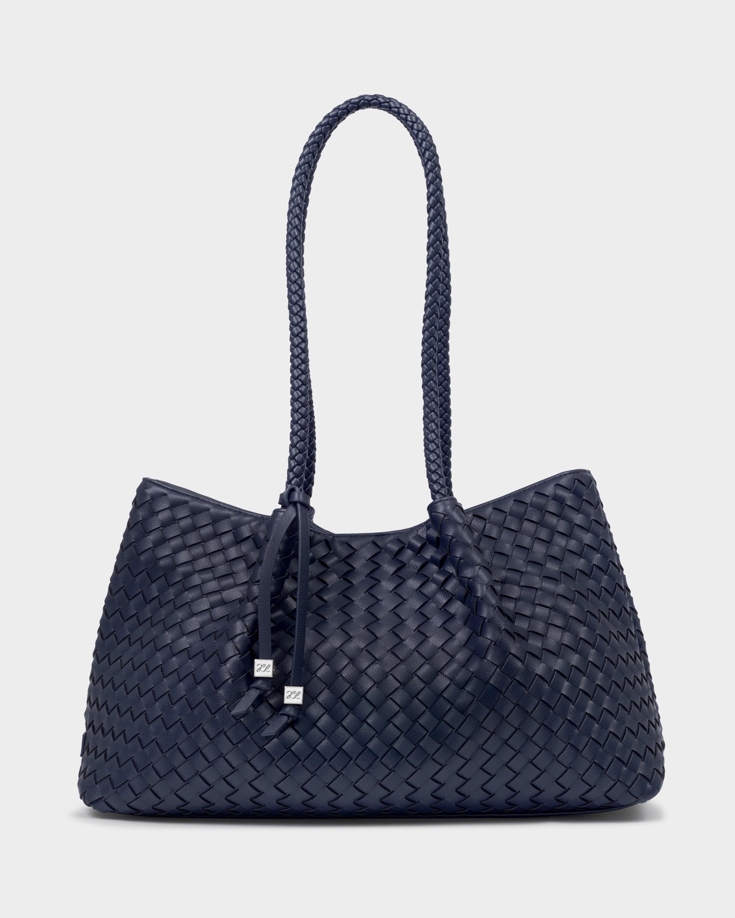 Katie Loxton Nova Navy blue woven handbag with a handle on a white background