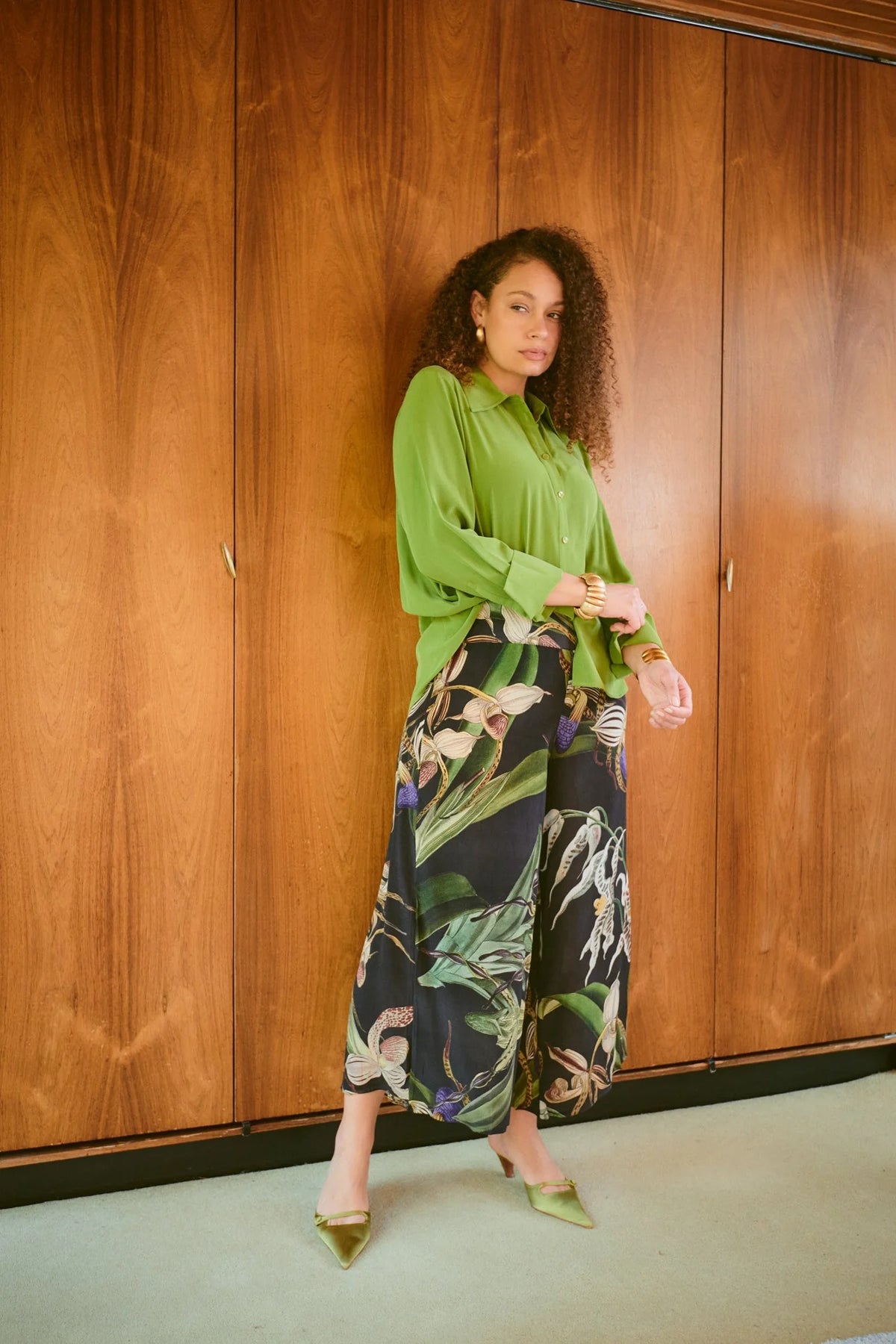 One Hundred Stars Orchid Black Crepe Palazzo Pants with botanical orchid print, black background and flowing wide-leg silhouette