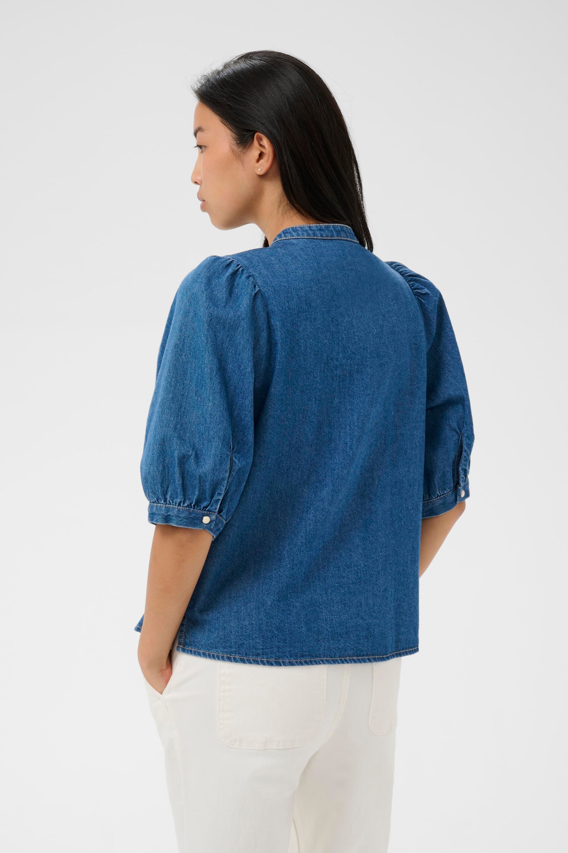 Woman wearing the Part two Alesia Denim Shirt with 3/4 sleeves and folded detailing at the front.
