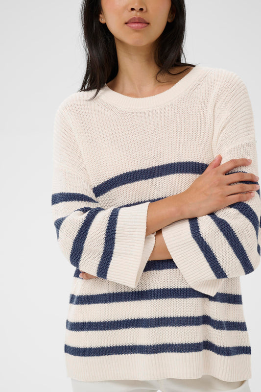 Woman wearing the Part Two Aliza white and navy striped sweater against a plain background