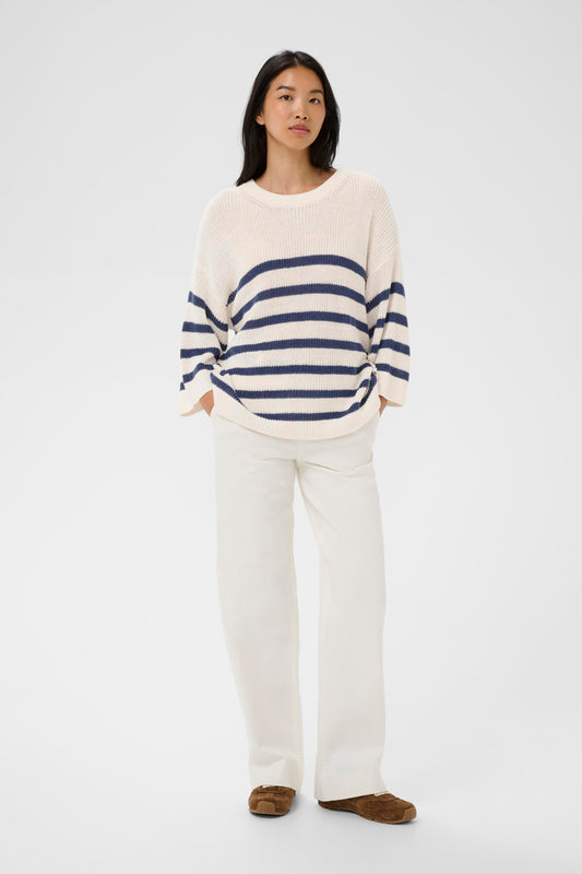 Woman wearing the Part Two Aliza white and navy striped sweater against a plain background