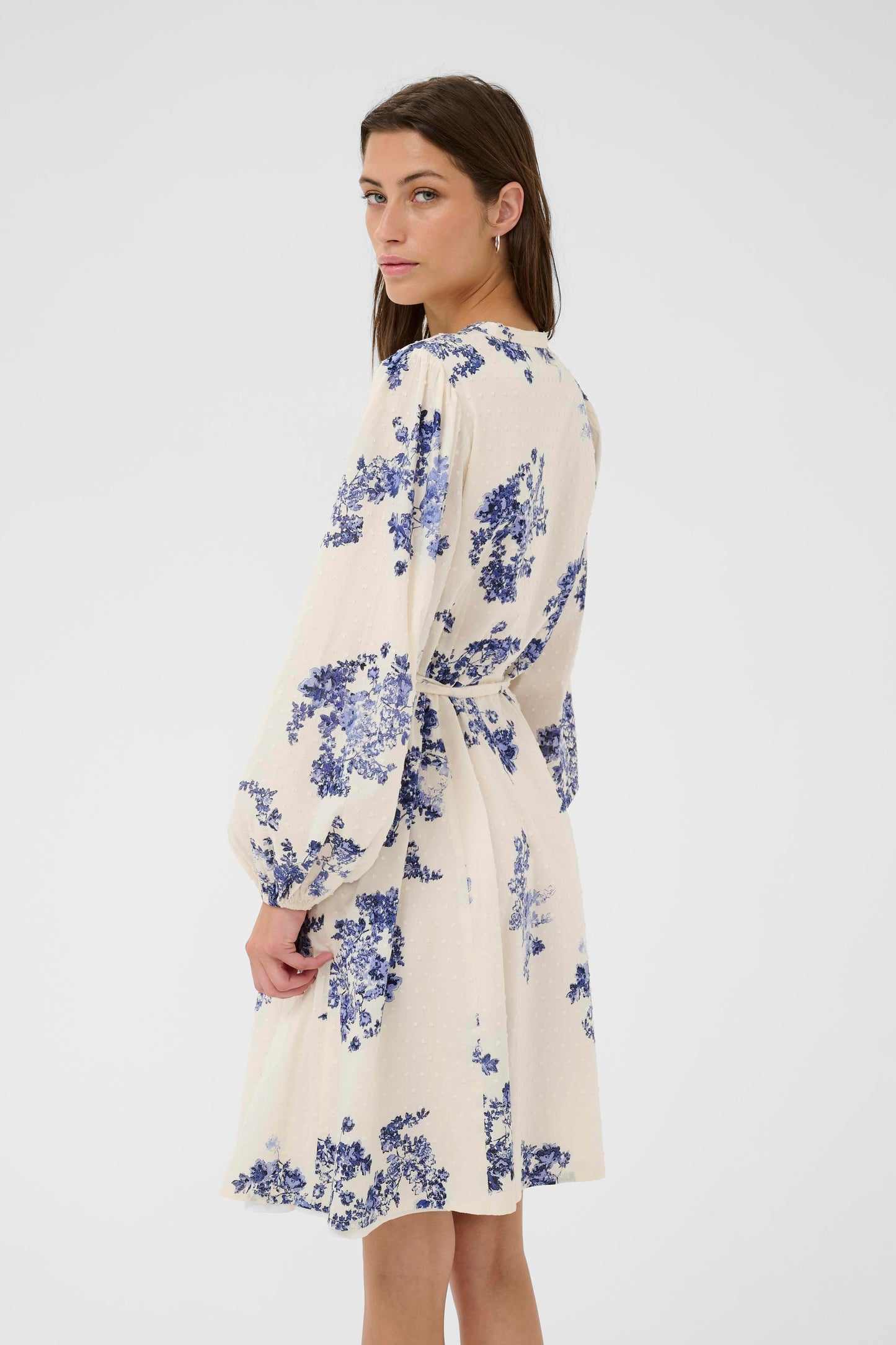 Woman wearing the Part Two Avira White and Blue floral dress on a white background