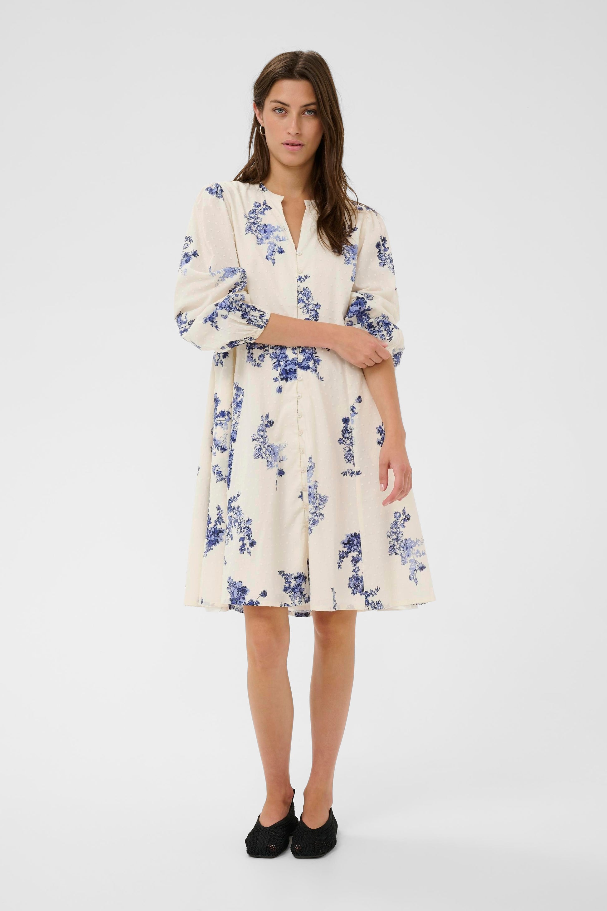 Woman wearing the Part Two Avira White and Blue floral dress on a white background
