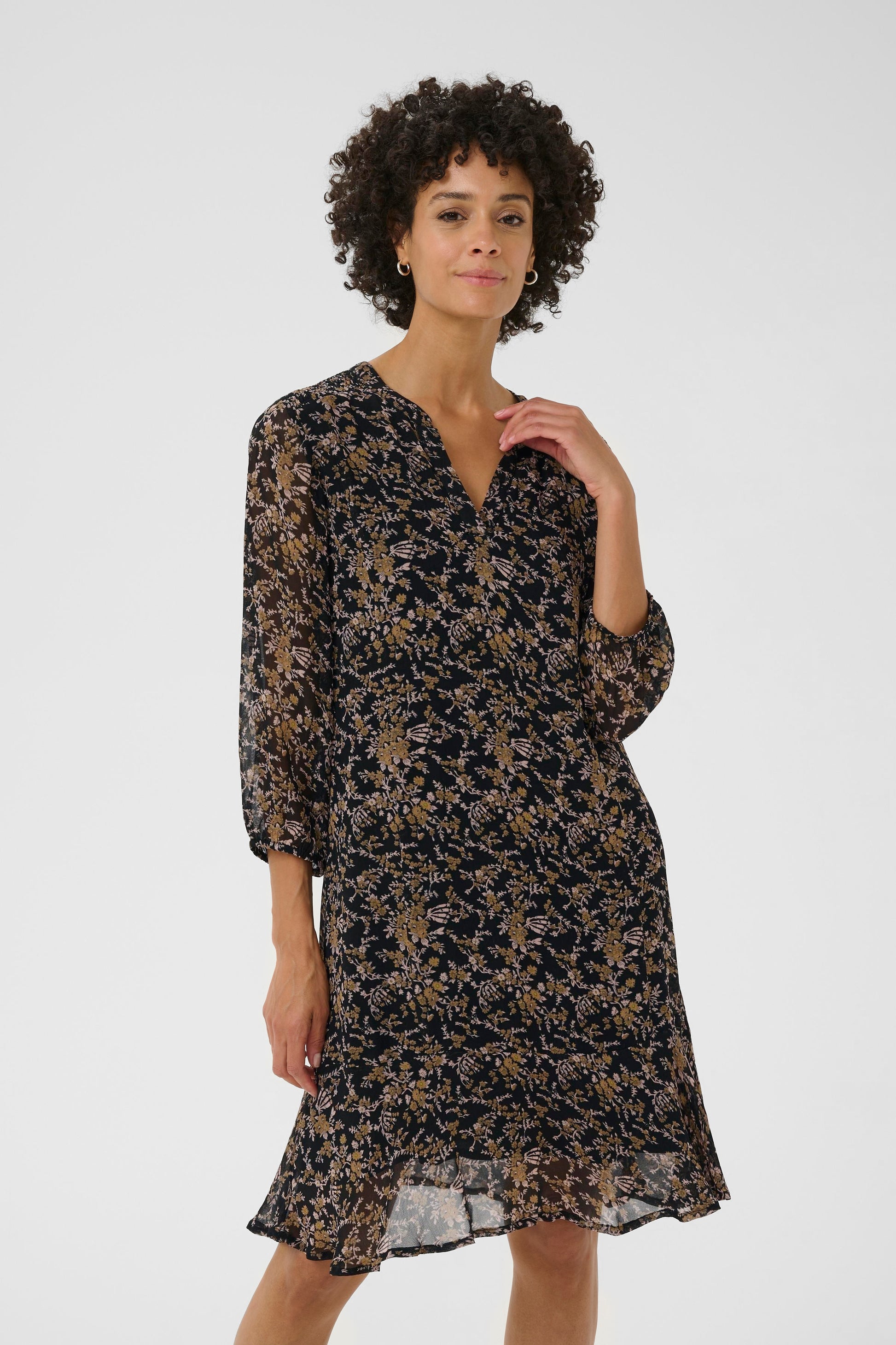 Woman wearing a floral dress on a white background