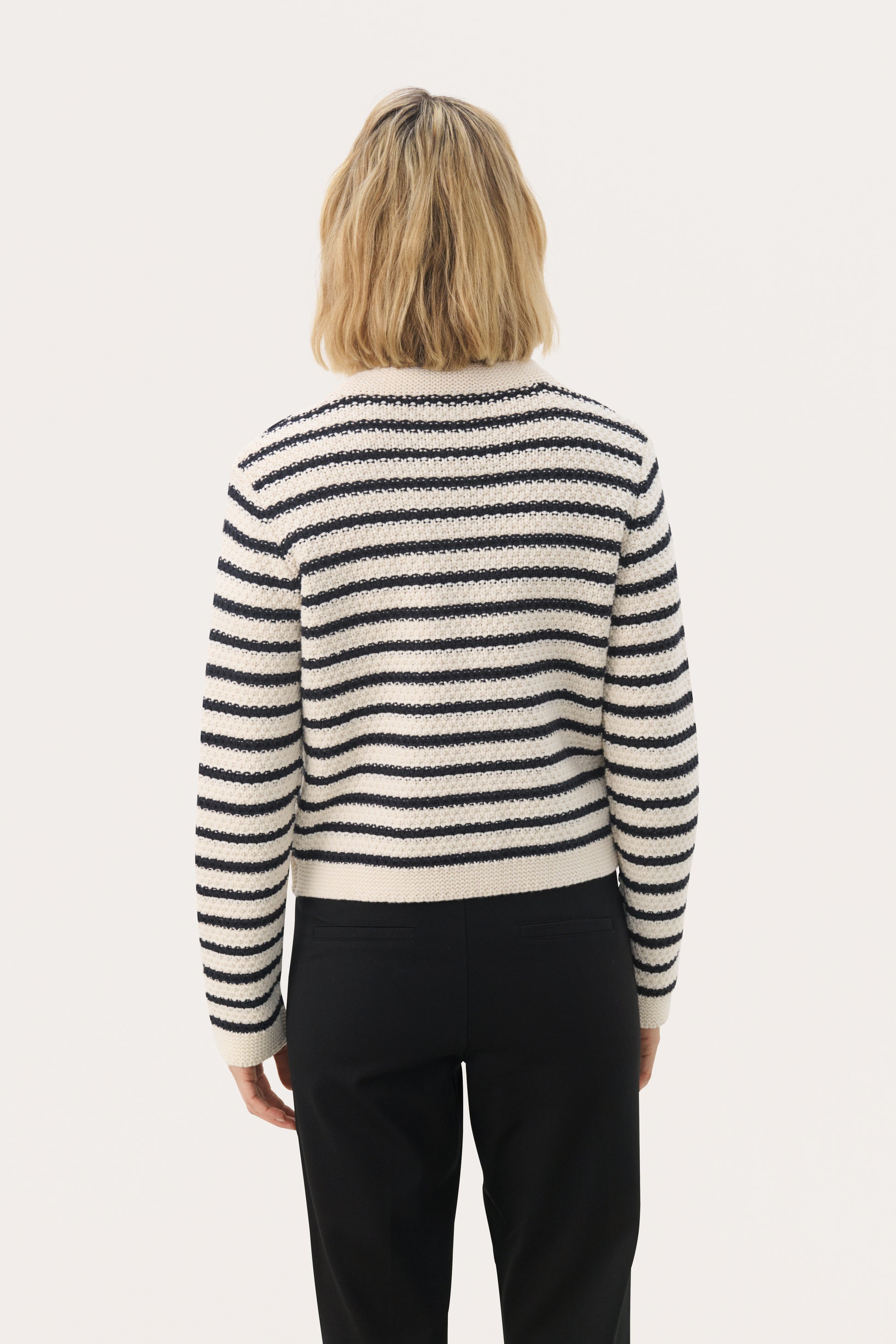 Woman wearing the Part Two Elmie cardigan in a dark navy stripe