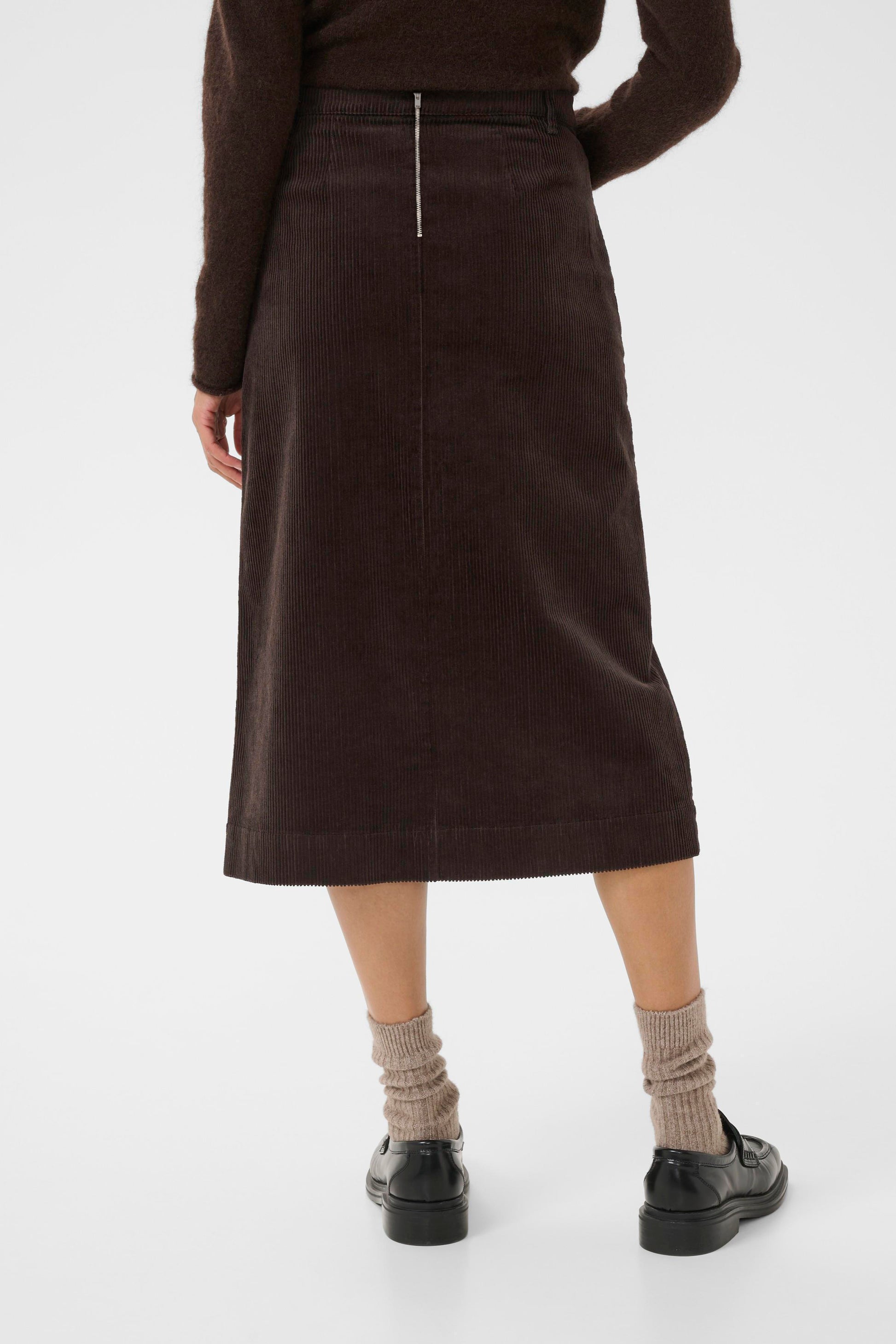 Woman wearing the part two shayla cord brown skirt sweater on a white background  view of the back