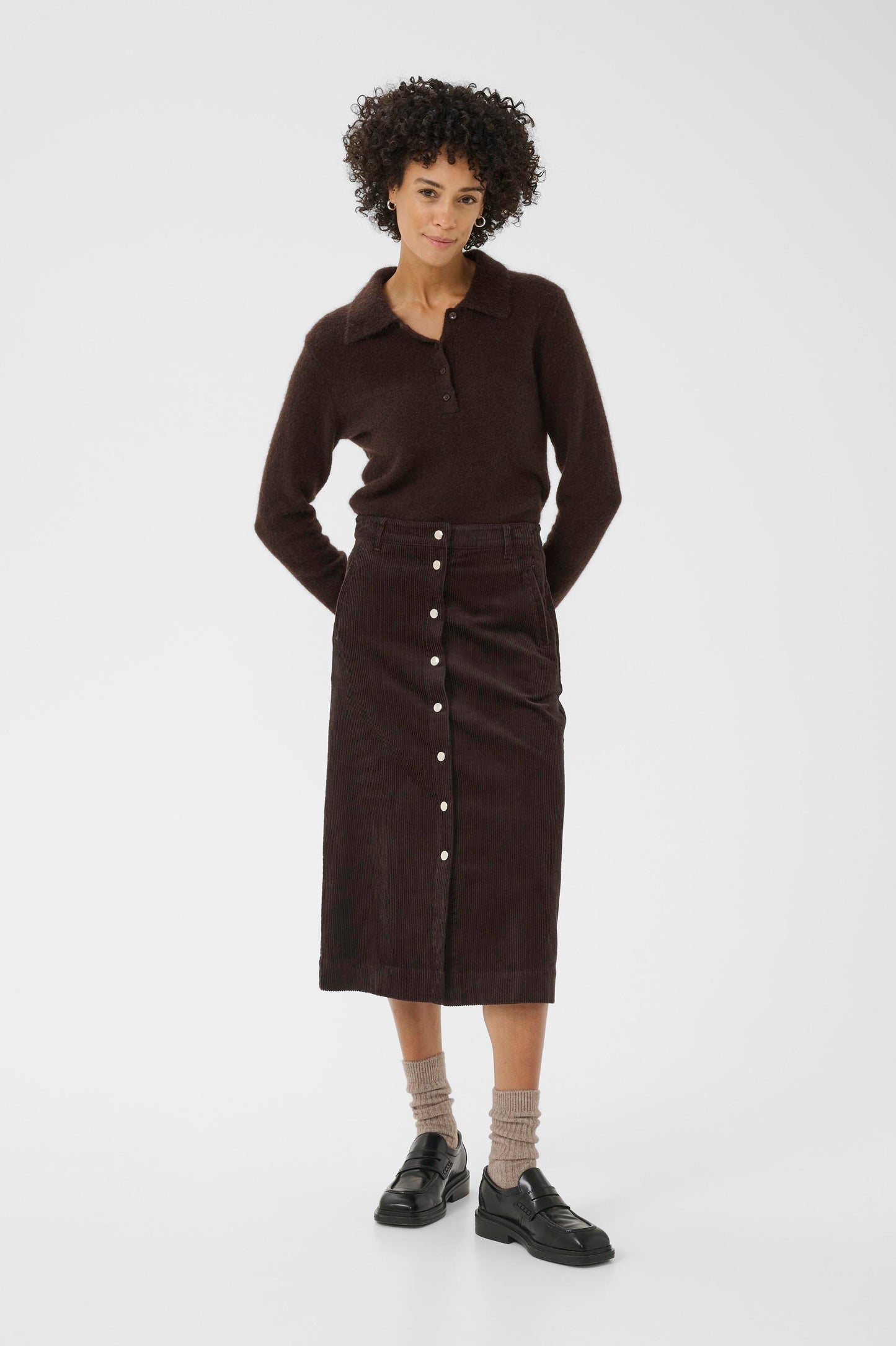 Woman wearing the part two shayla cord brown skirt sweater on a white background