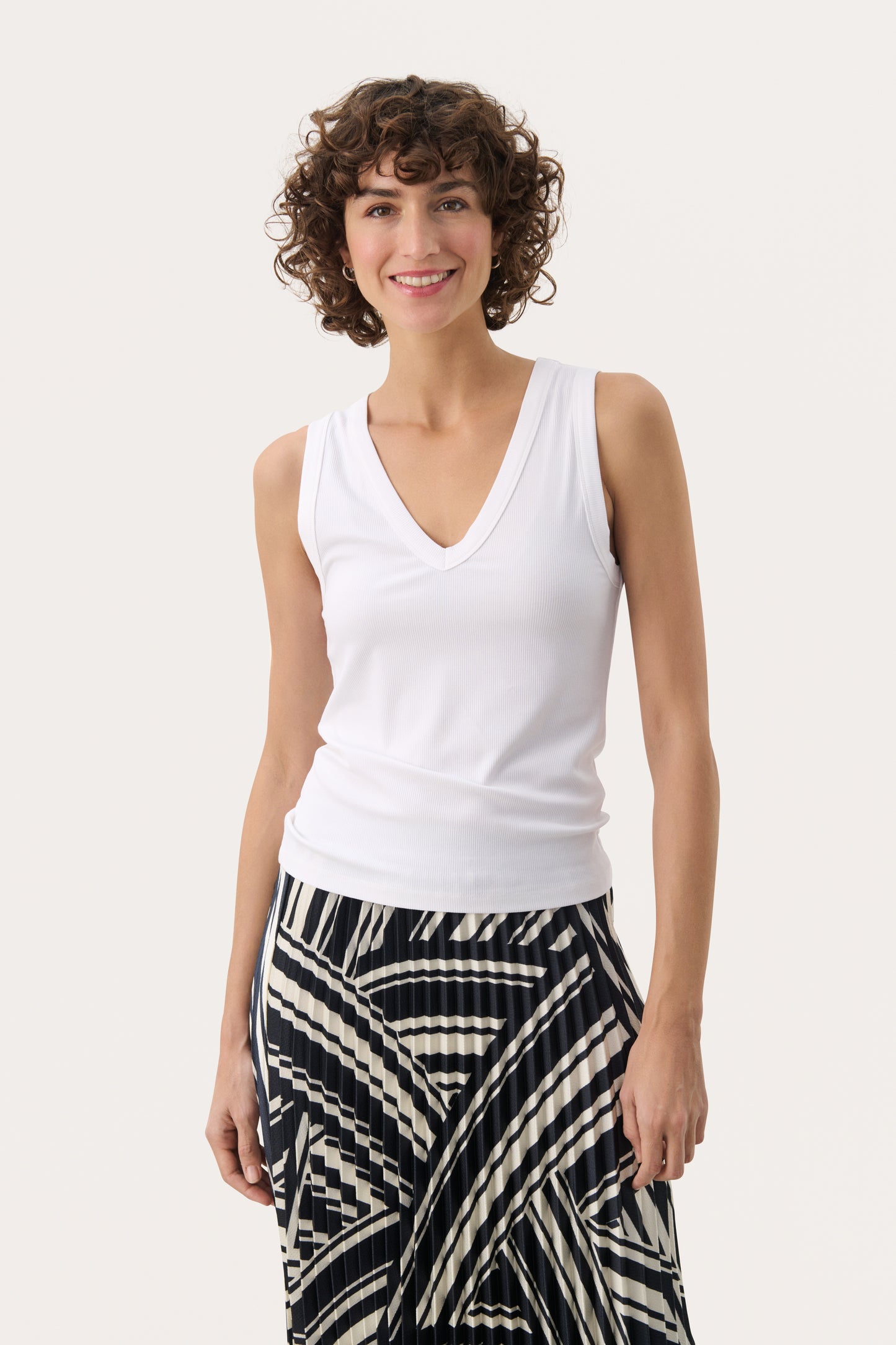 Woman wearing the Part Two white tank top