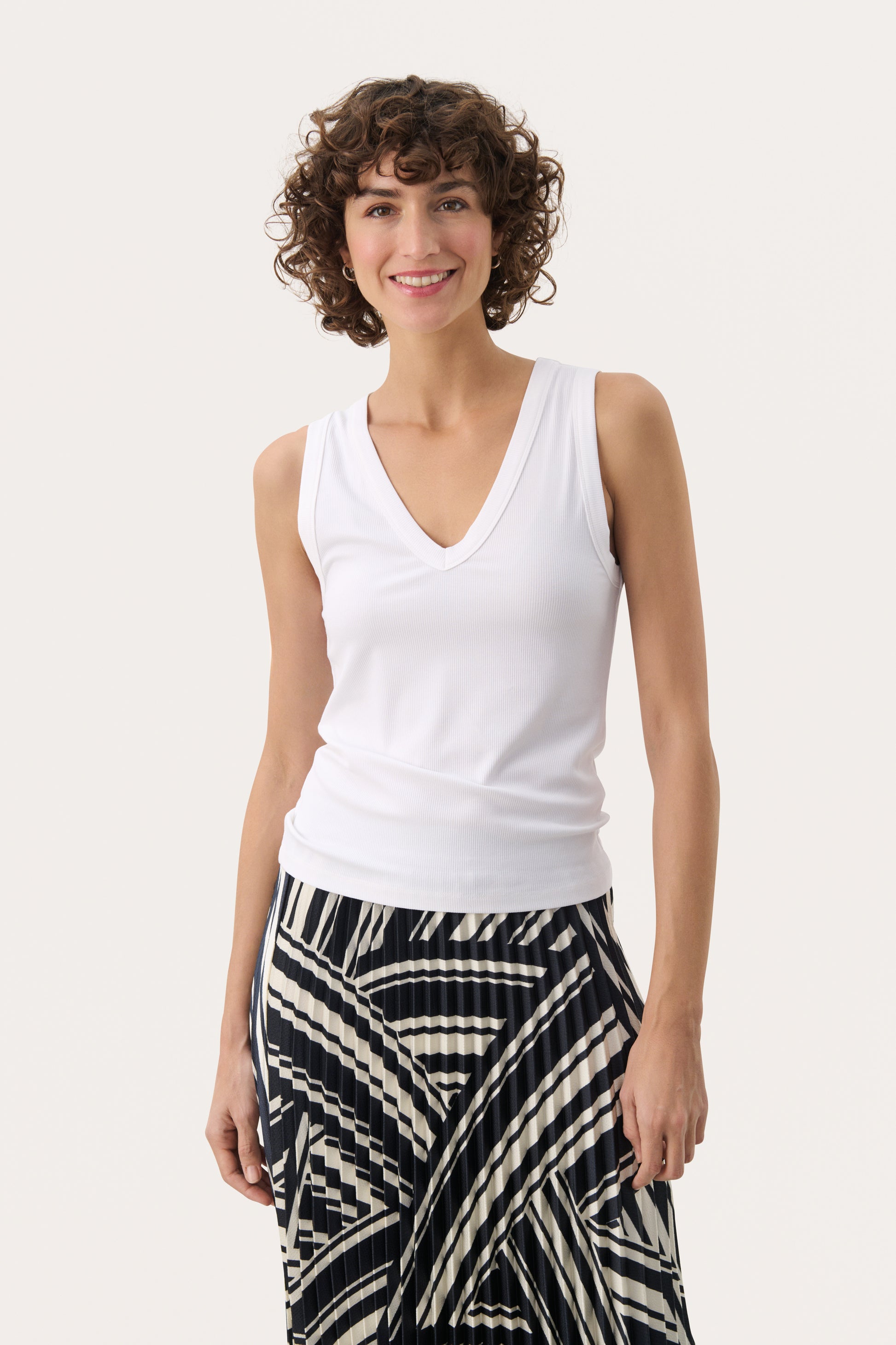 Woman wearing the Part Two white tank top