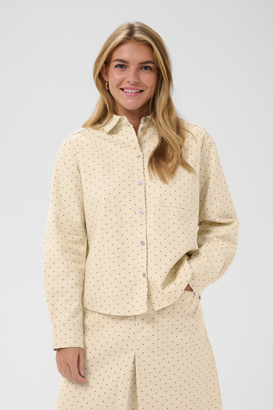 Woman wearing the Saint Tropez Patricia beige polka dot shirt