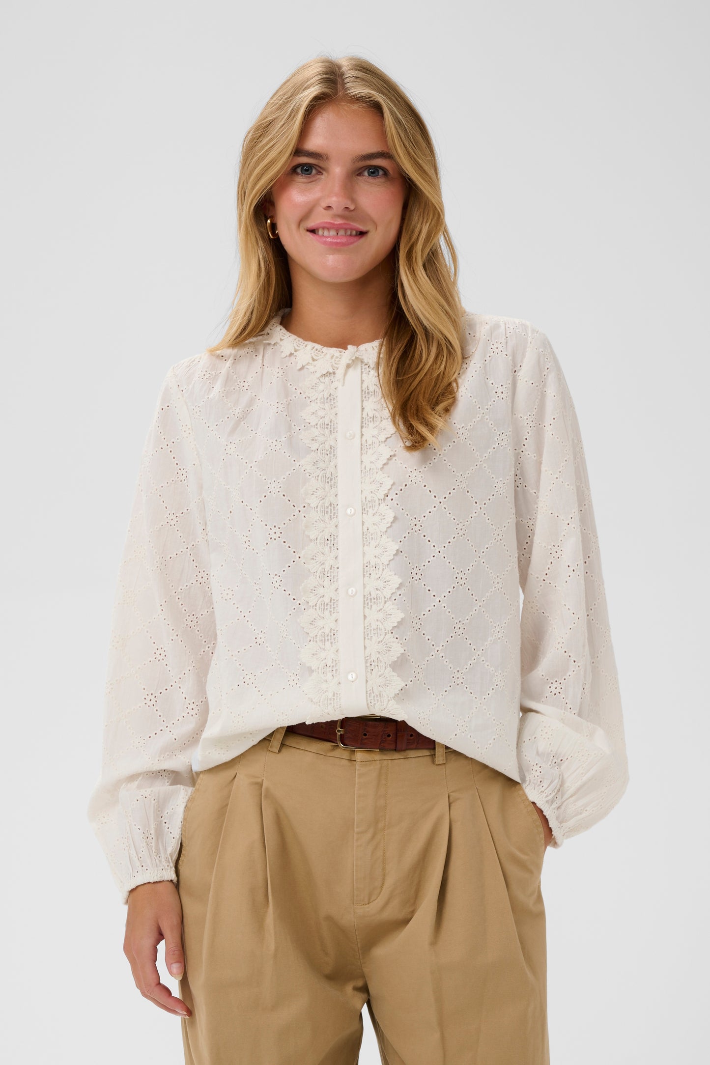 Woman wearing a the Petunia white broderie anglaise blouse 