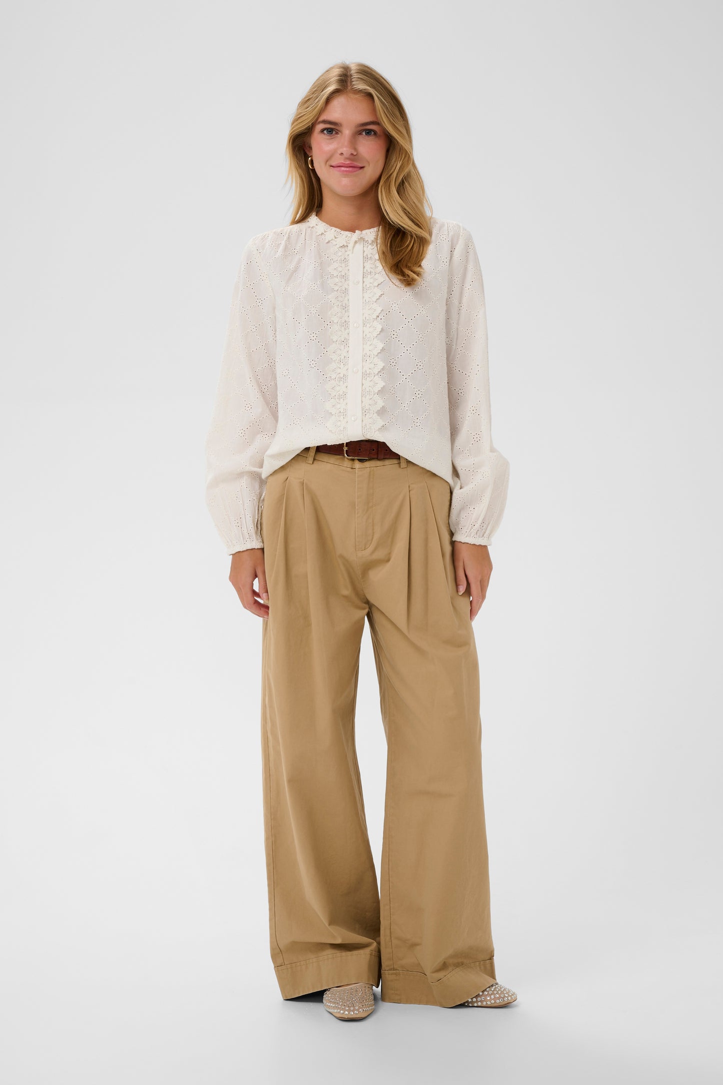 Woman wearing a the Petunia white broderie anglaise blouse 