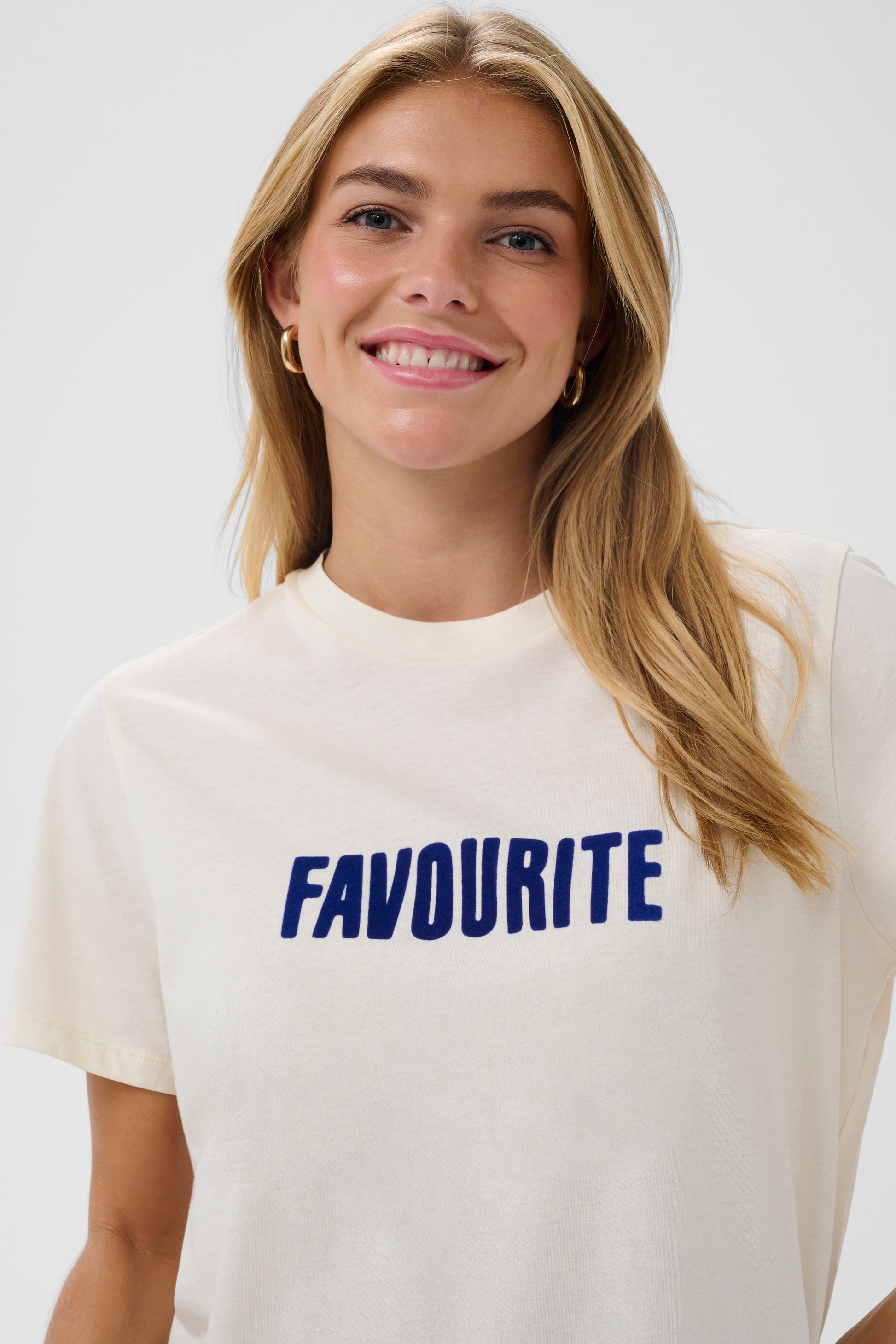 Cream Saint Tropez t-shirt with 'FAVOURITE' printed in blue on a white background