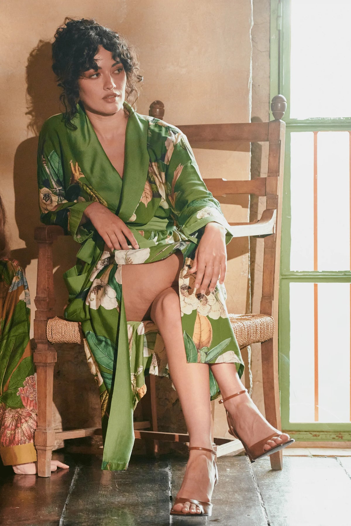 One Hundred Stars Rhodoleia Green Gown featuring an intricate botanical floral print in green tones with a flowing longline silhouette