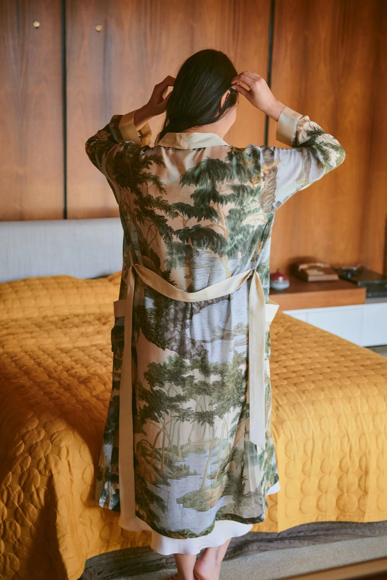 Woman wearing the one hundred stars gown with rivers and trees on it
