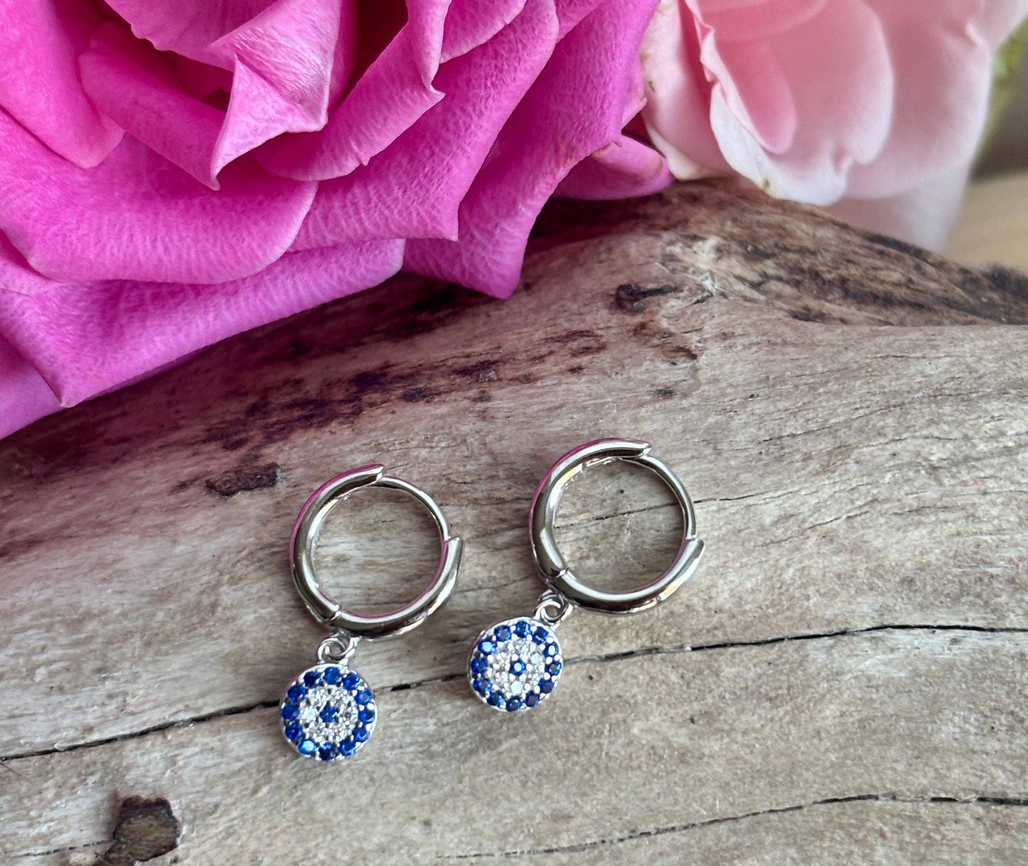Ocean Ripples 925 sterling silver blue cubic zirconia huggie earrings.