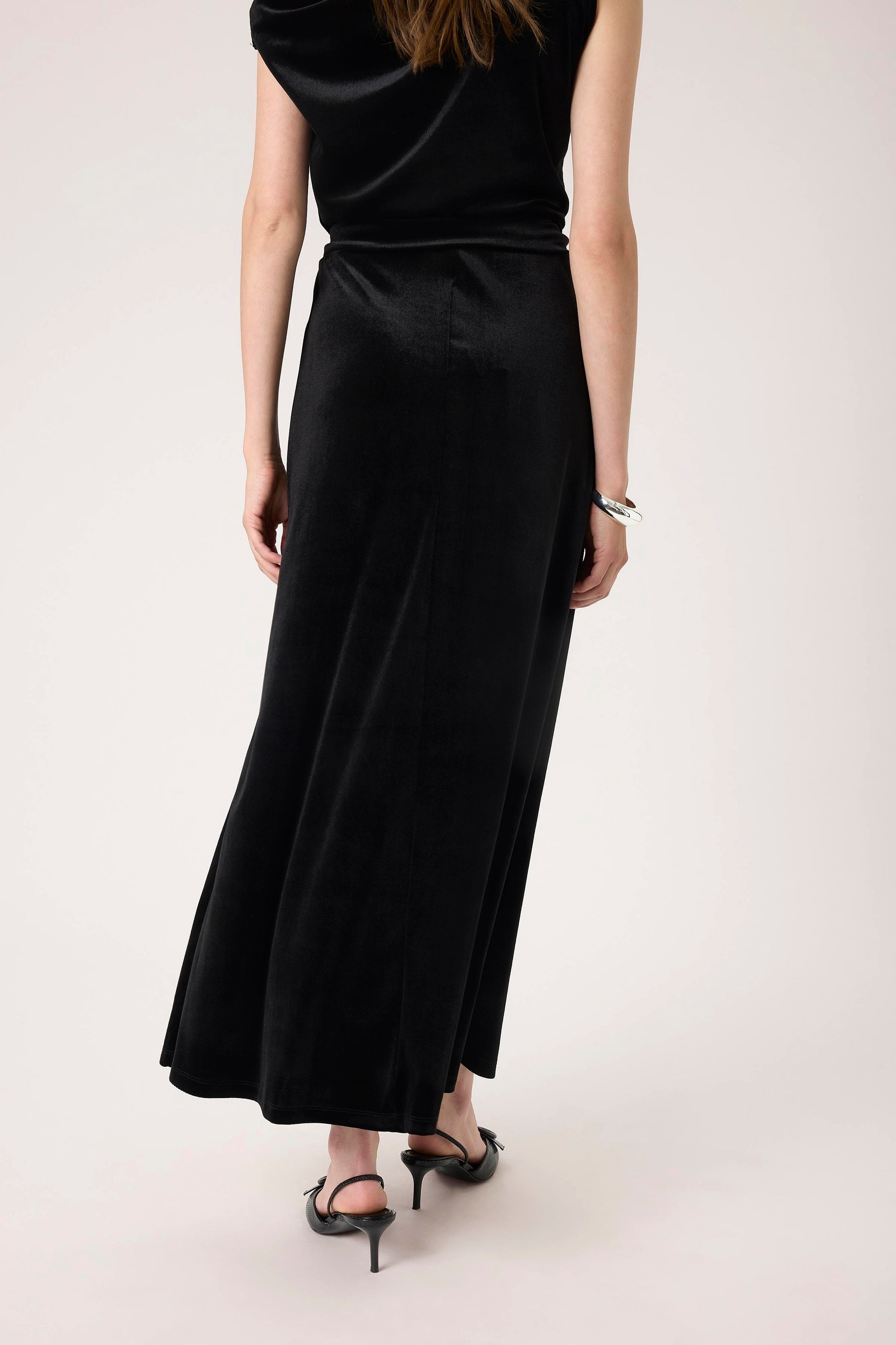 Woman wearing the Soaked in Luxury Black Velera Velvet Skirt